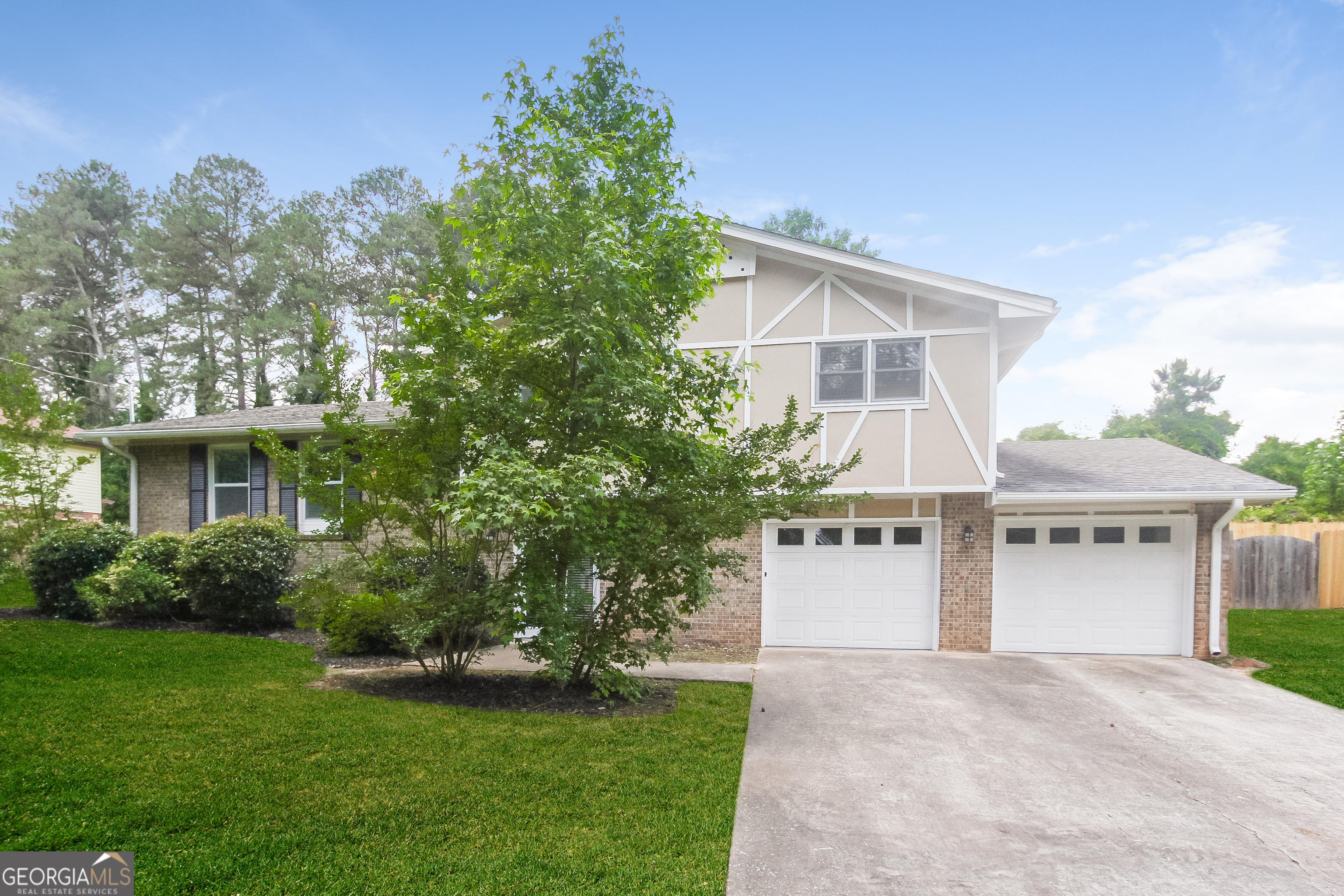 a front view of a house with a garden and yard