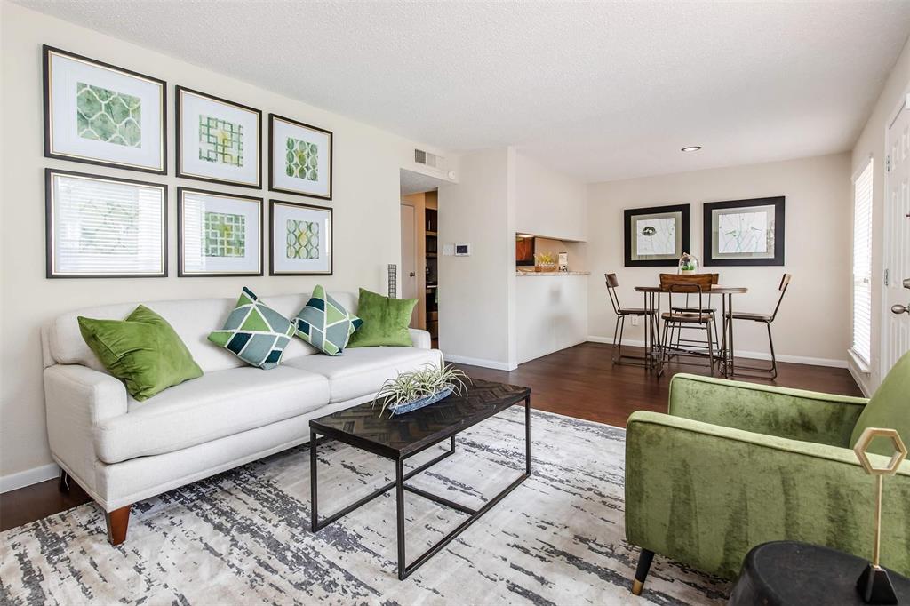 a living room with furniture and painting on the wall