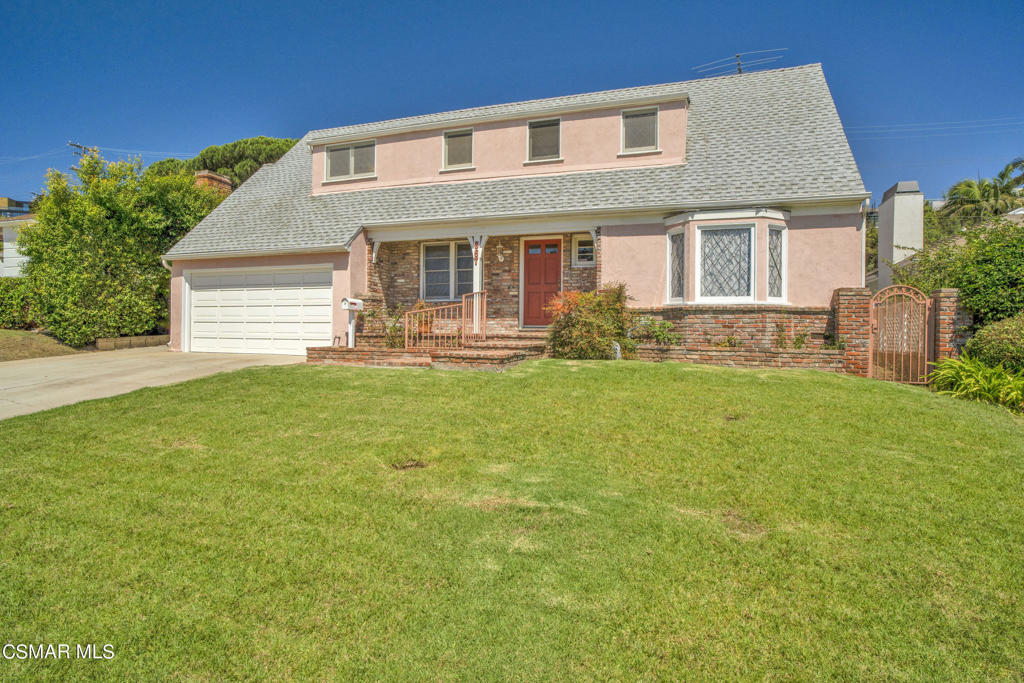 a front view of house with yard and outdoor seating