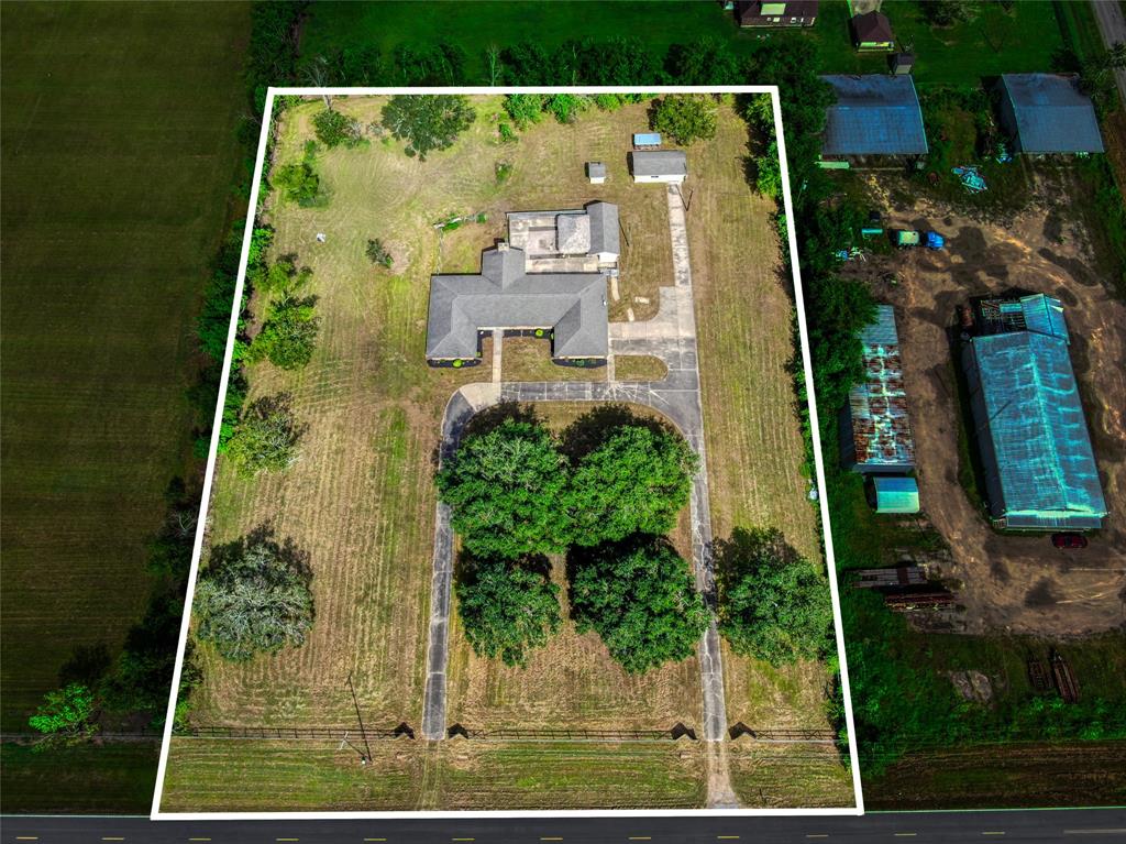 3 unrestricted acres of your very own!  You can see the house, the palapa in the back, the bonus room, mini kitchen and full bath beside it, the well house, the detached workshop with the coop behind.  You decide what kind of coop!