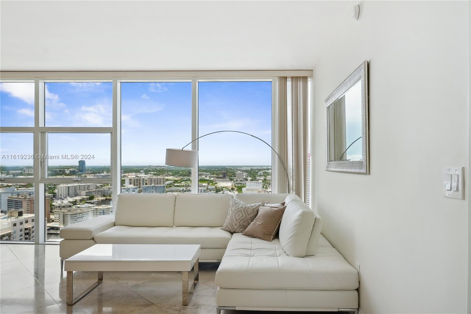 a living room with furniture and a large window