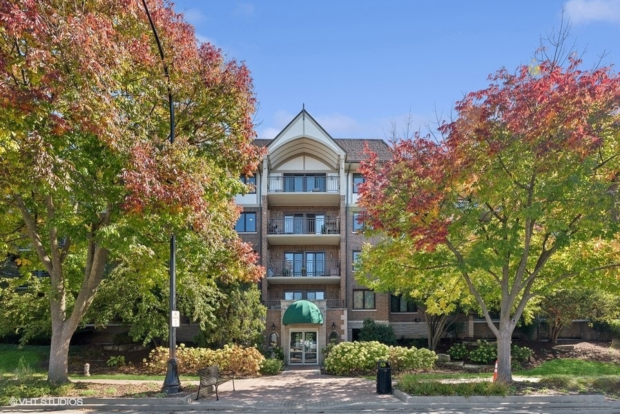 a front view of a building with trees