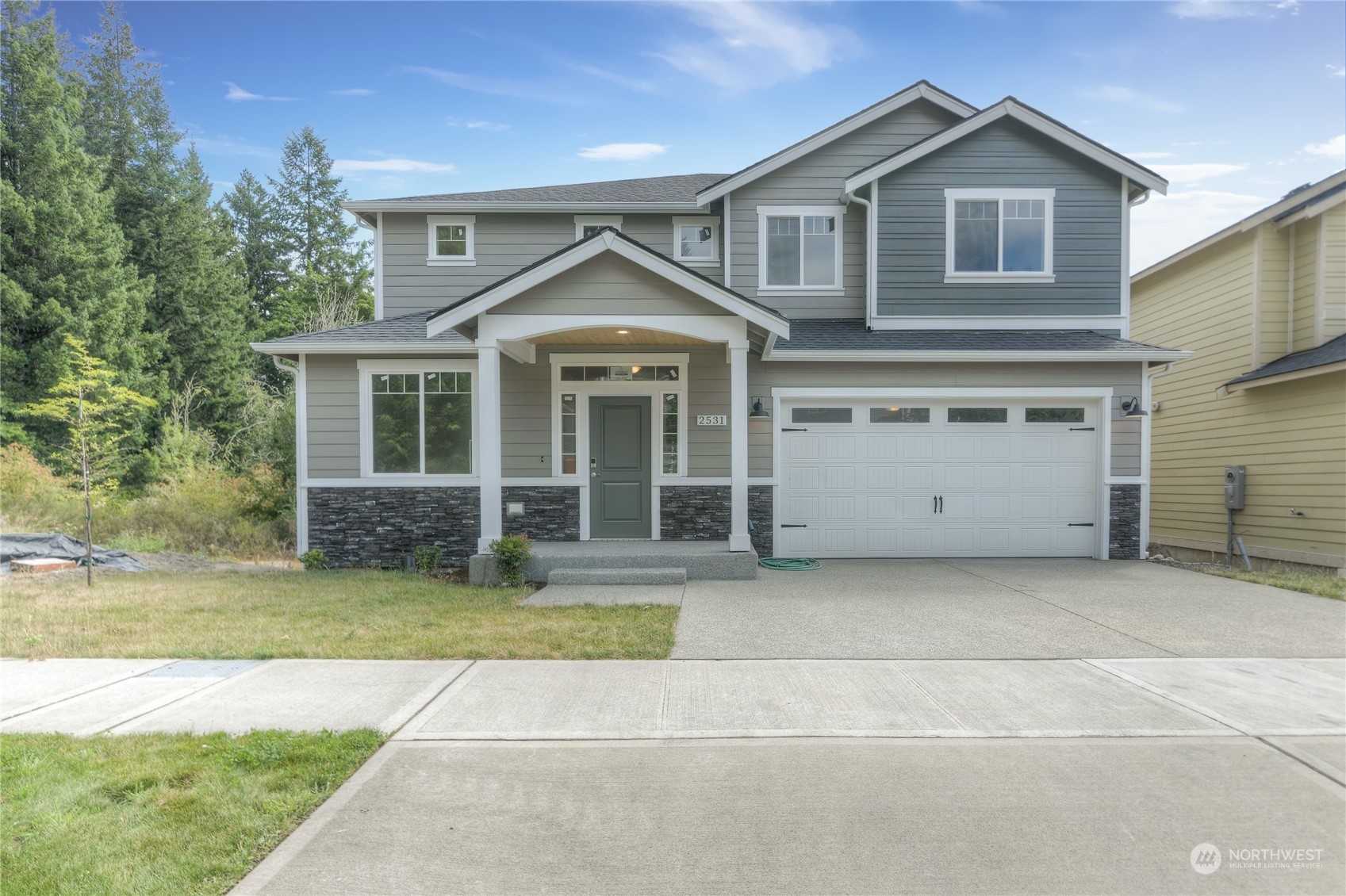 a front view of a house with a yard and garage