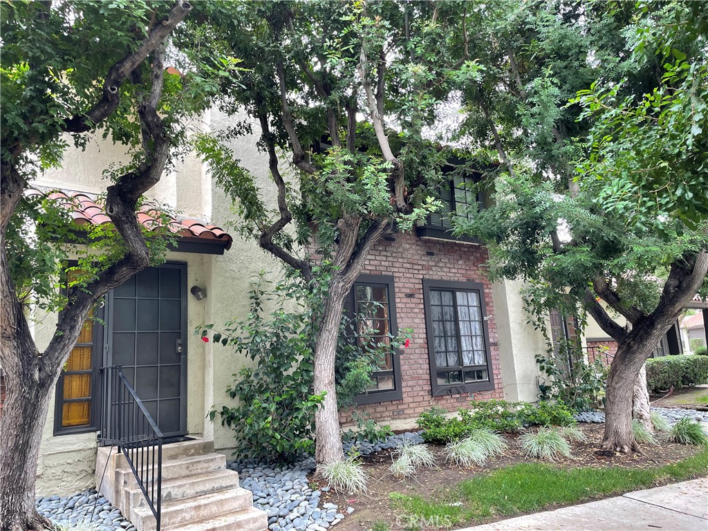 front view of a house with a tree