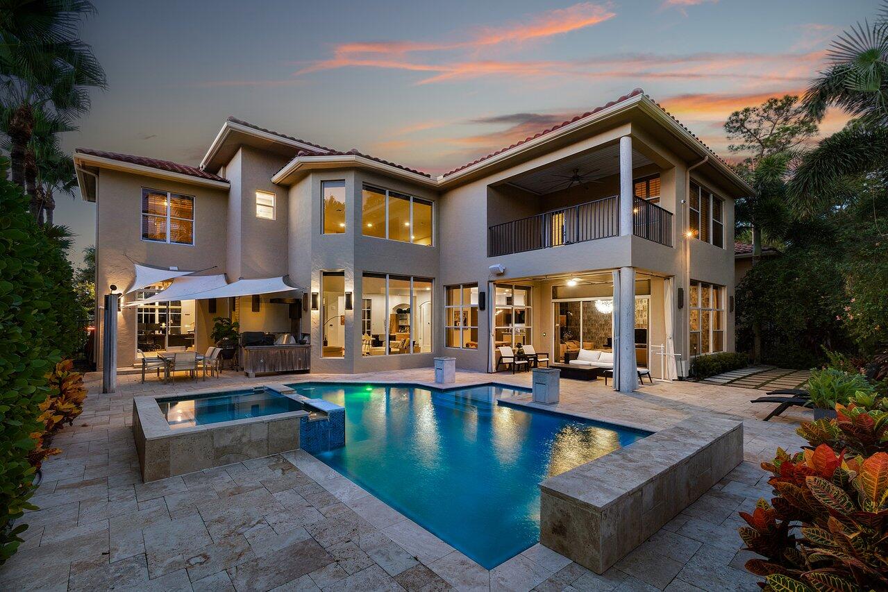 a view of a building with swimming pool and sitting area