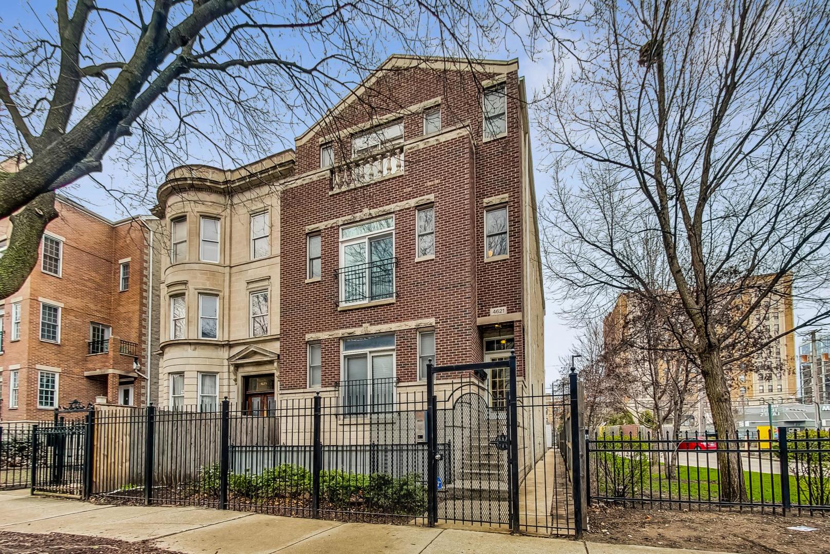 a front view of a residential apartment building with a yard