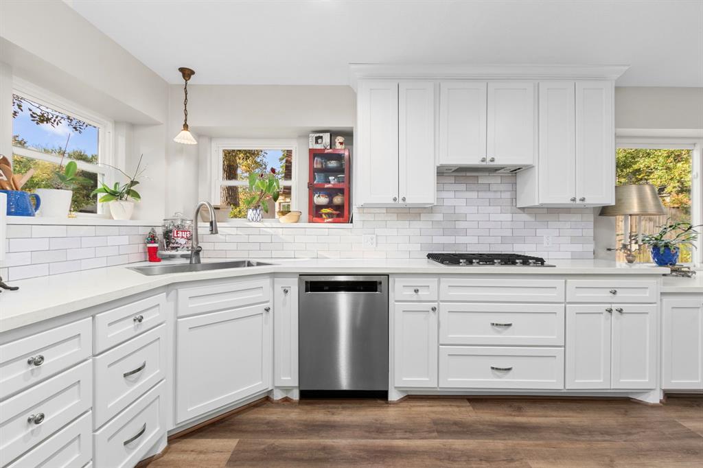 a kitchen with cabinets appliances and a window