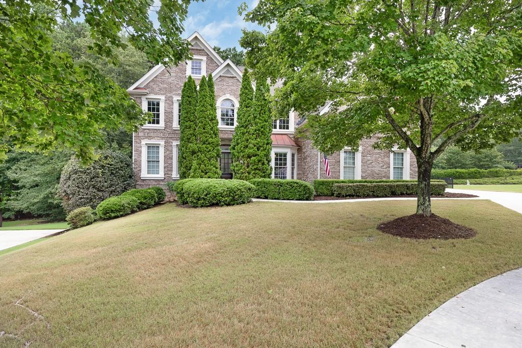 a front view of a house with a yard