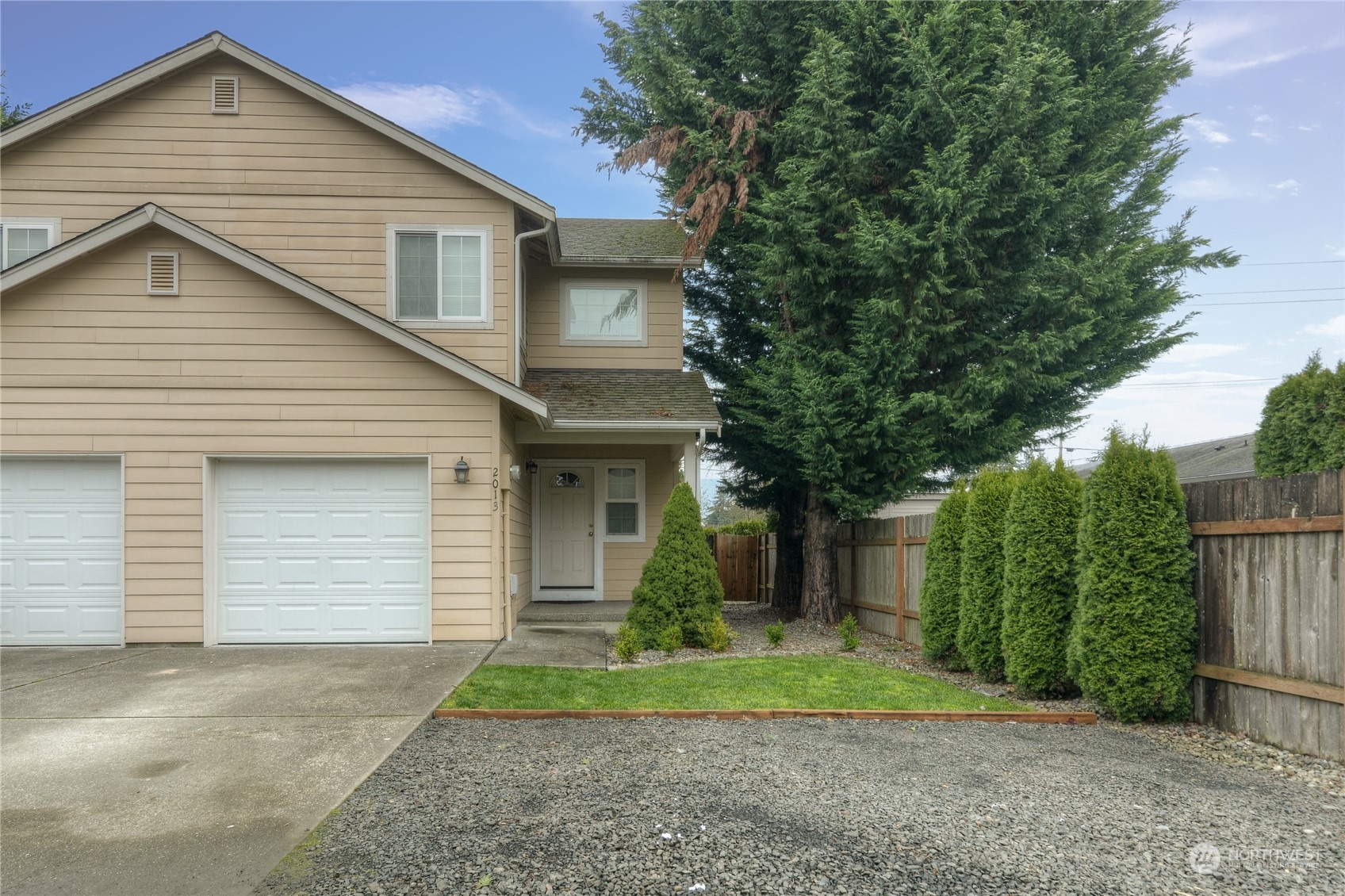 a view of a house with a yard and plants