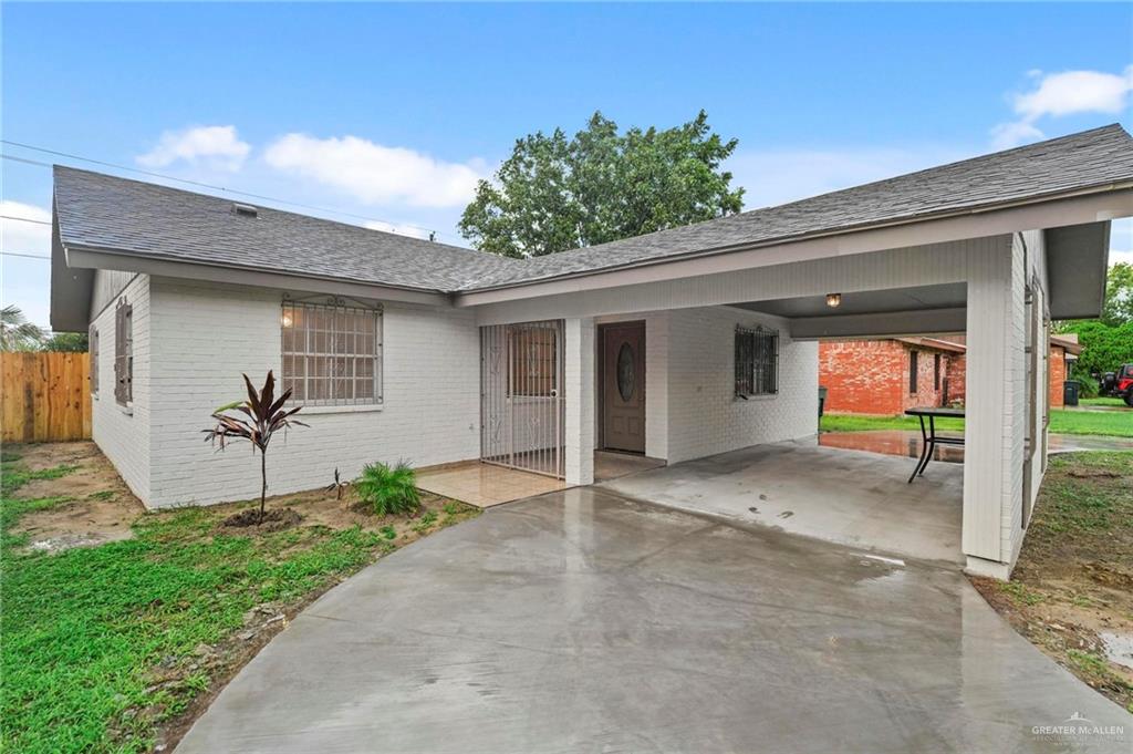 Single story home featuring a carport