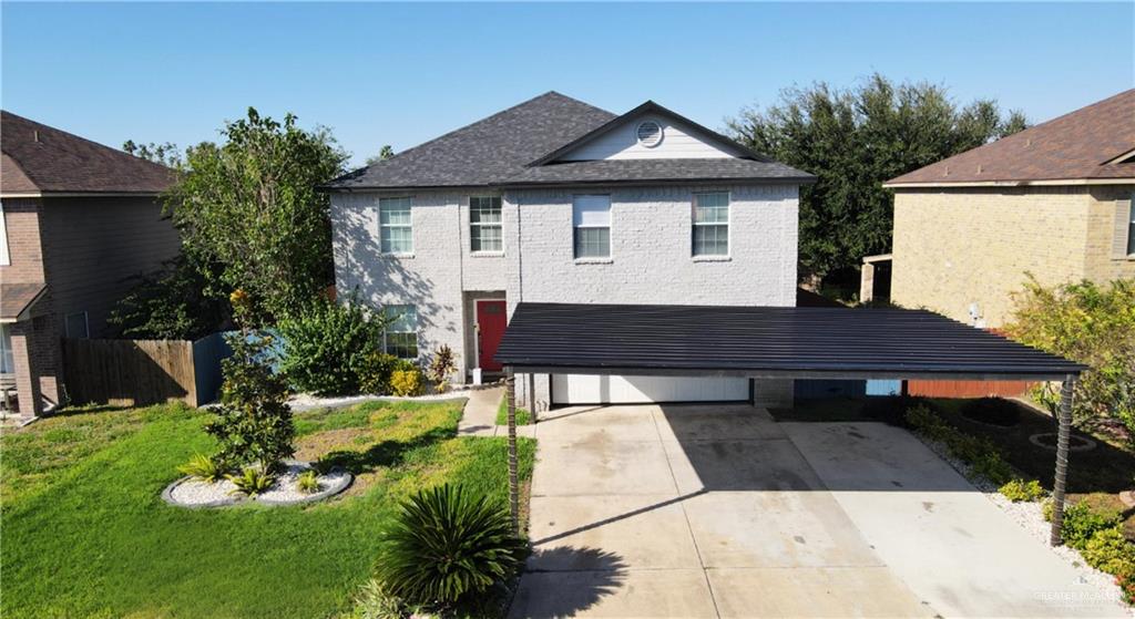 a view of a house with a yard patio and fire pit