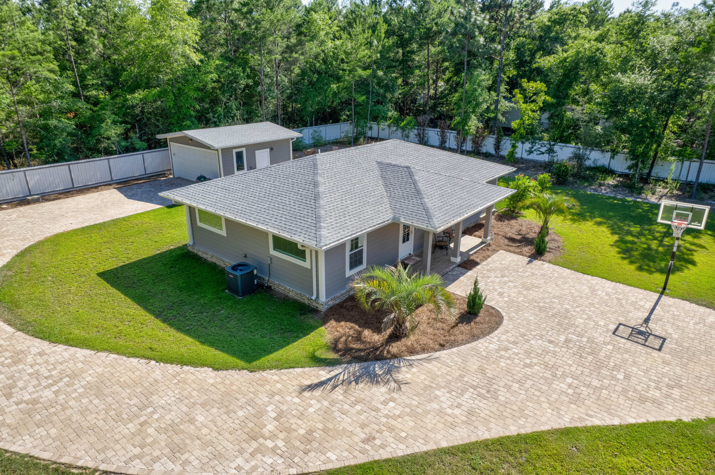 a aerial view of a house with a yard and potted plants