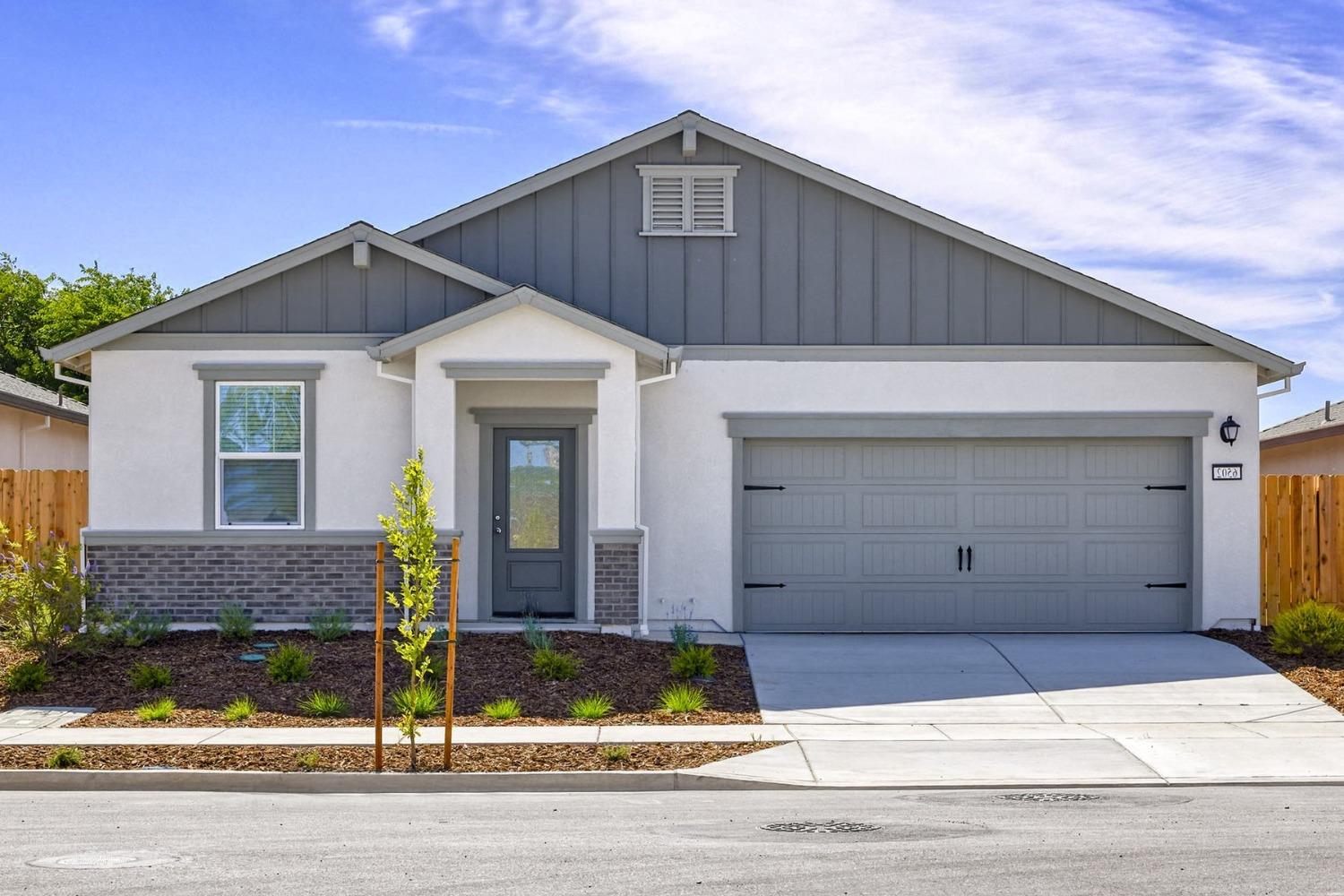 a front view of a house with garage