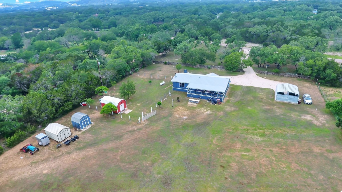 an aerial view of a house with a yard