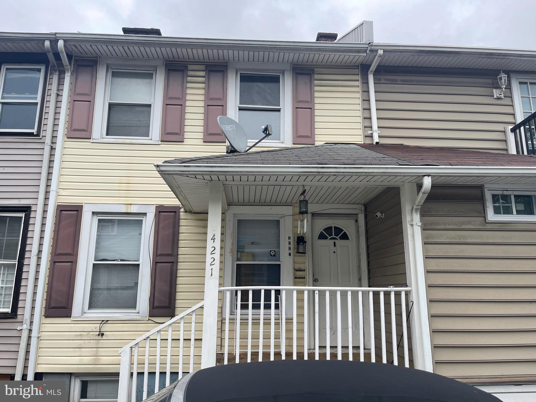 a view of a house with a small deck