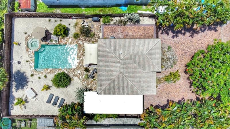 an aerial view of a house with a yard and garden