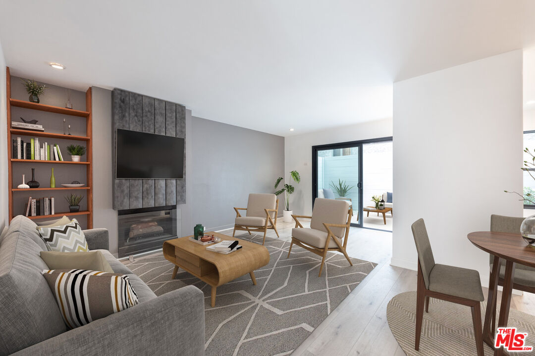 a living room with furniture fireplace and a flat screen tv