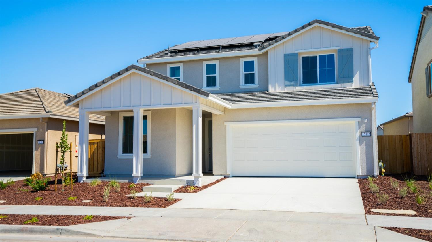 a front view of a house with garage