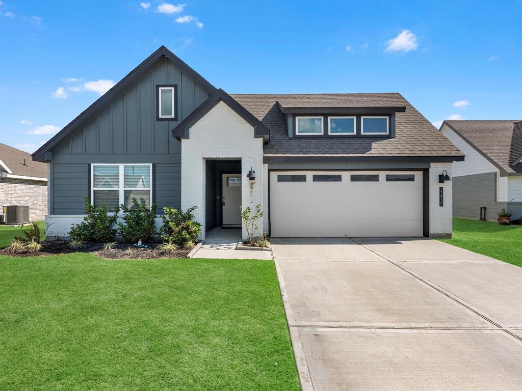 a front view of a house with a yard and garage