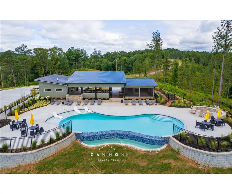 a view of a house with pool and chairs