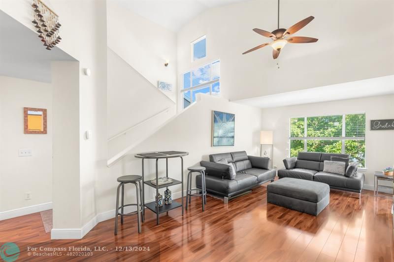 a living room with furniture ceiling fan and a window