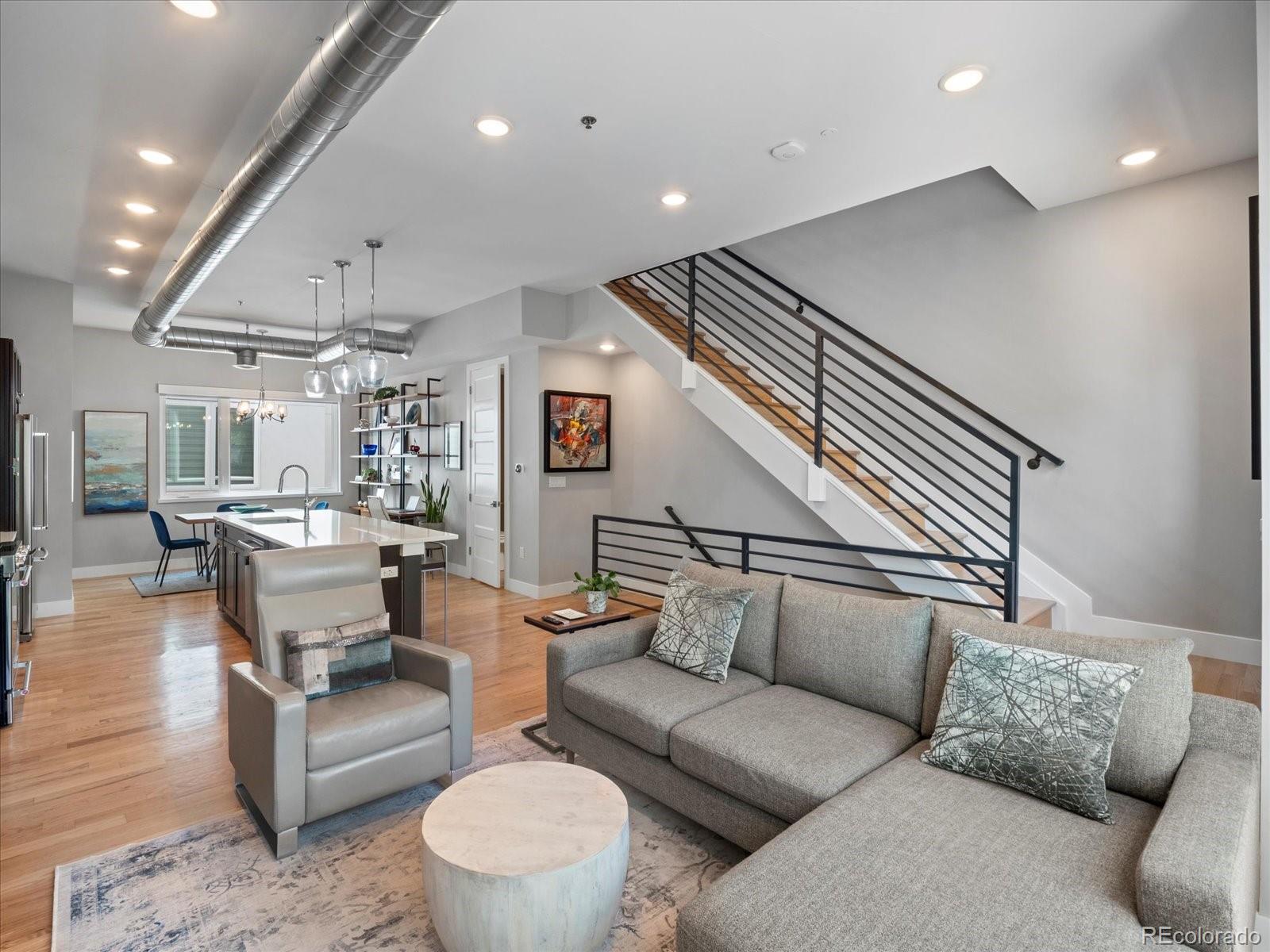 a living room with furniture and kitchen view