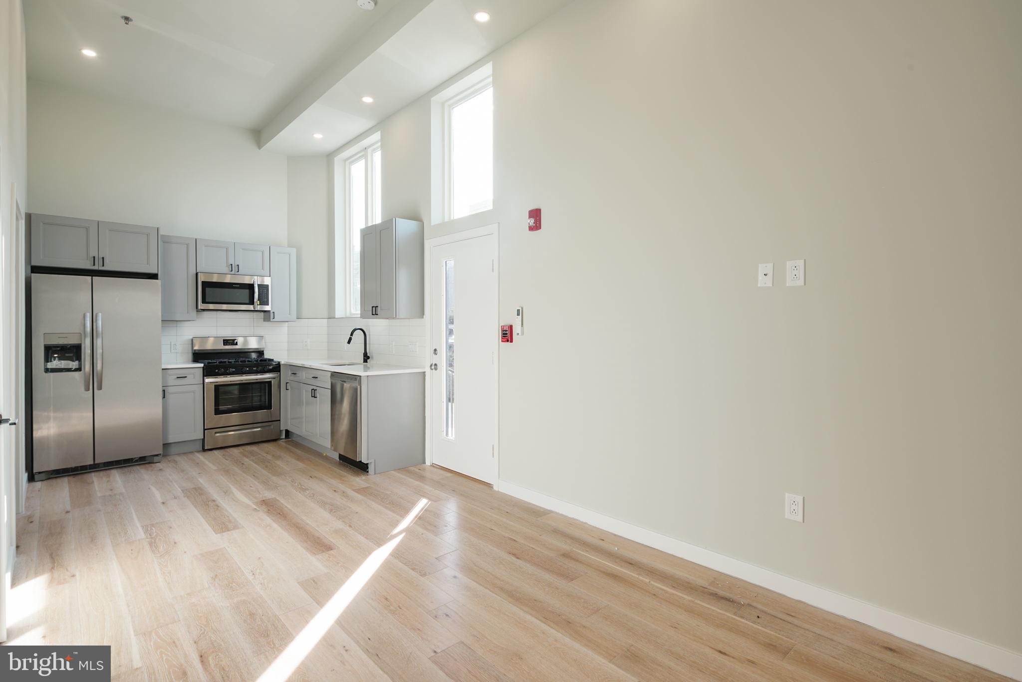 a kitchen with stainless steel appliances a refrigerator and a sink