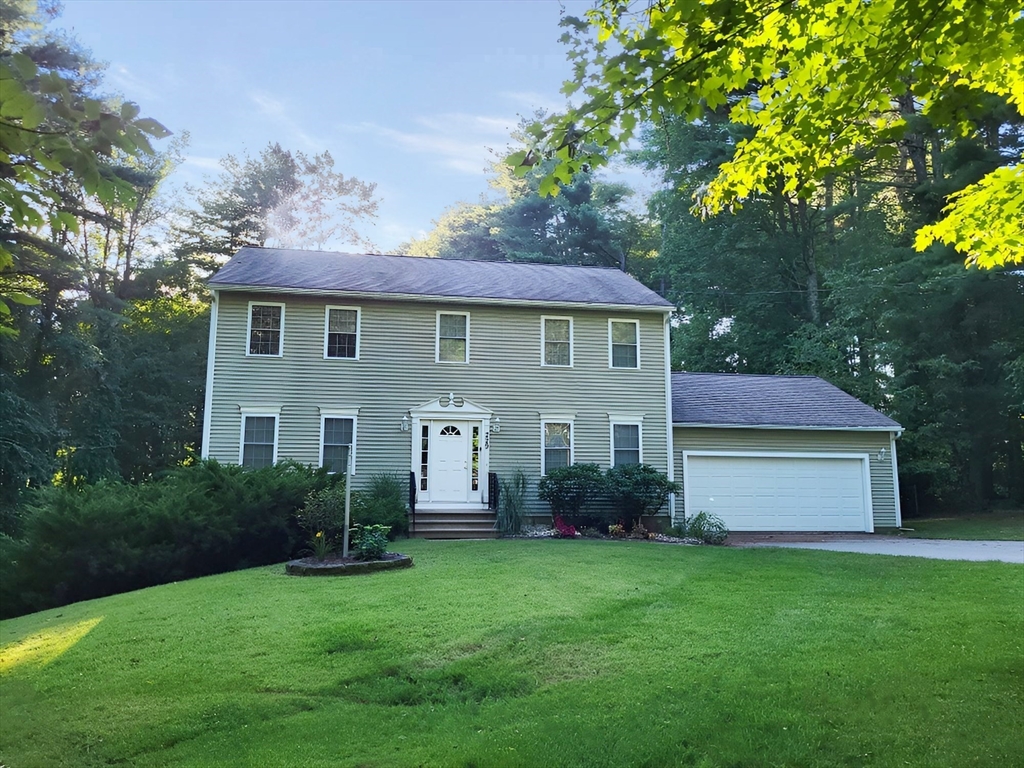 a front view of house with yard and green space