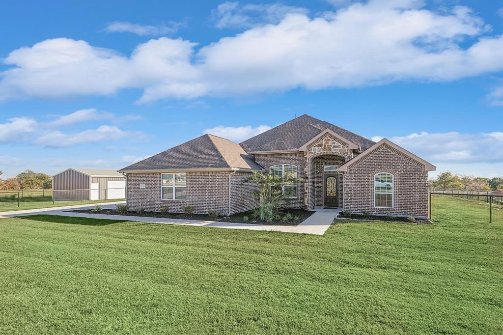 a front view of a house with a yard