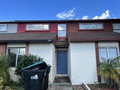 a front view of a house with plants