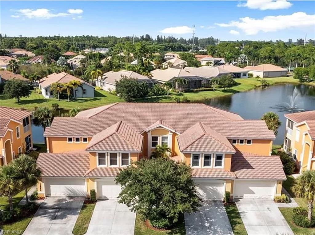 an aerial view of house with yard and lake view