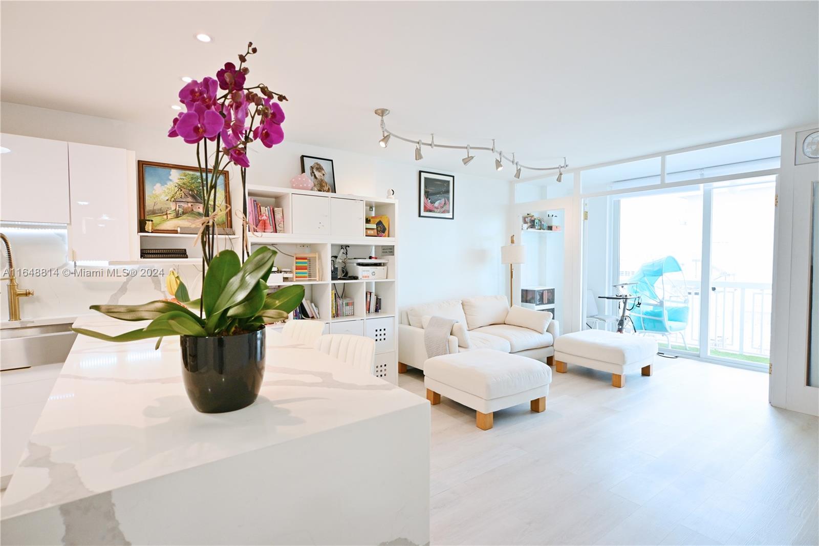 a living room with furniture and flowers