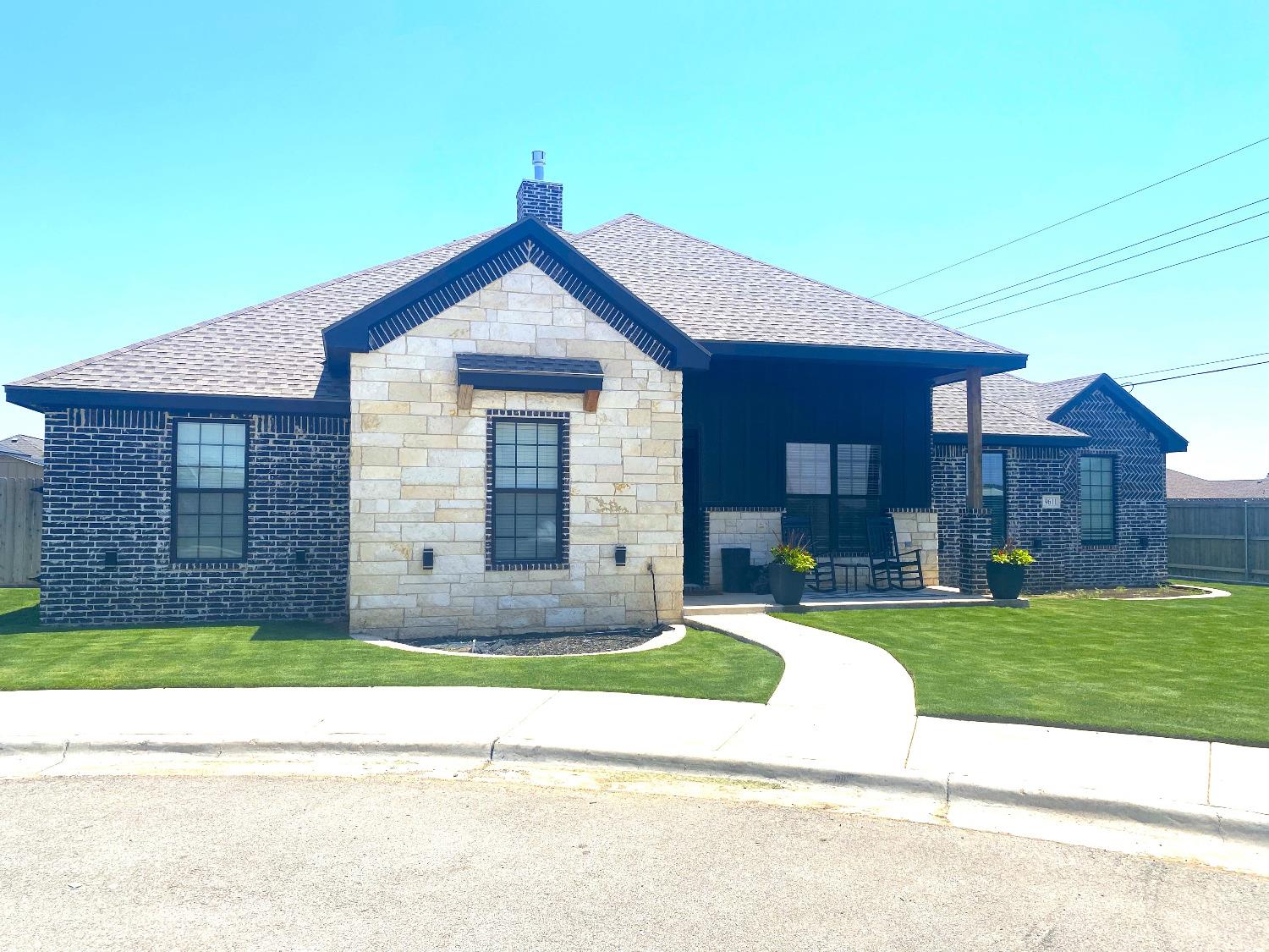 a view of a brick house with a yard