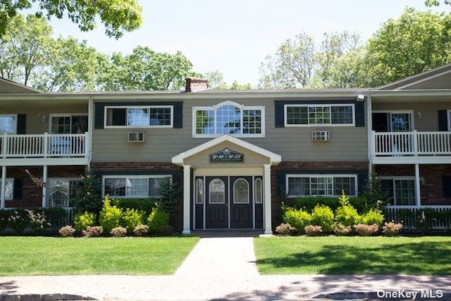 a front view of a house with a garden and plants