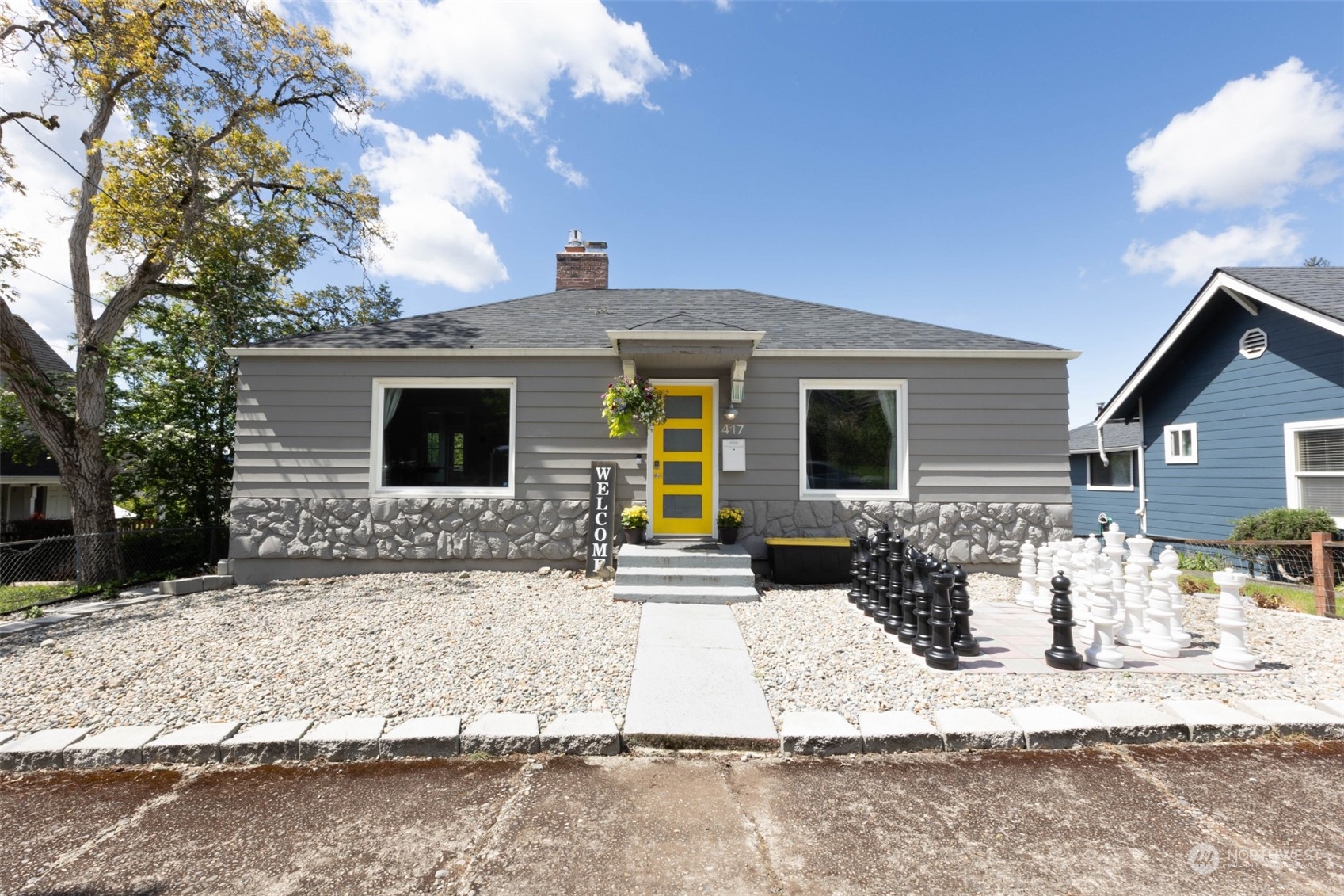 a front view of house with yard outdoor seating and barbeque oven