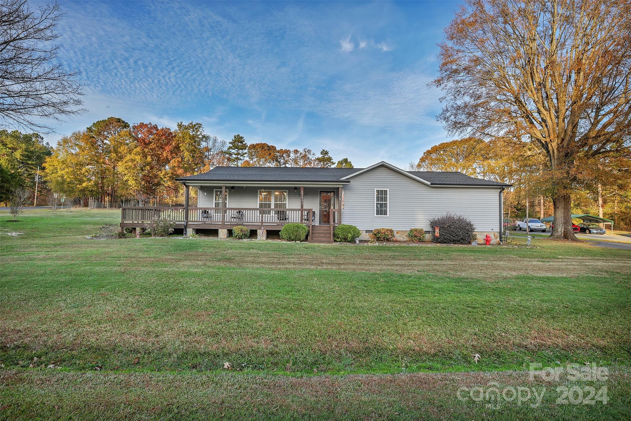 a front view of house with outdoor space and trees