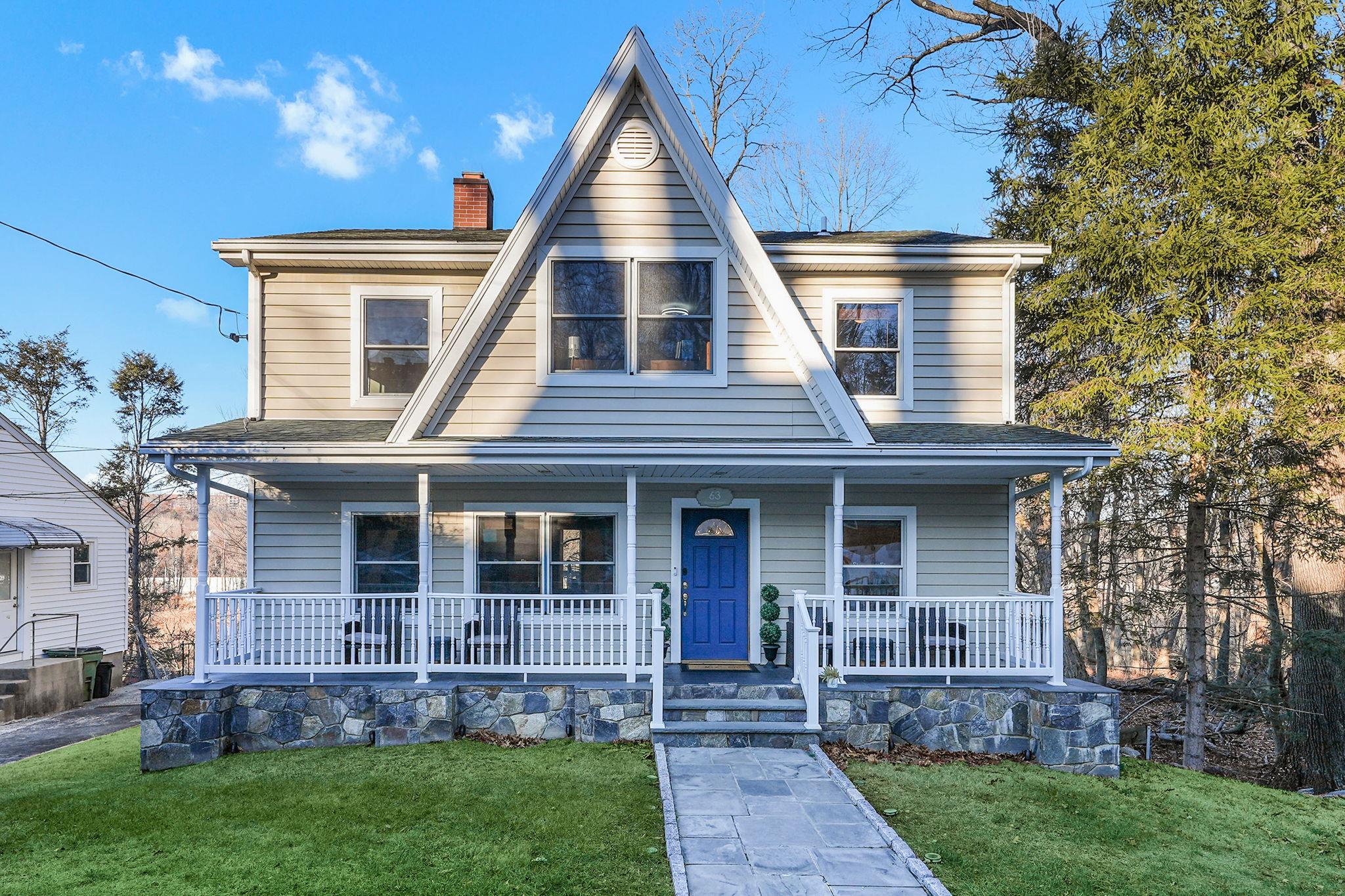 View of front facade with flagstone walkway to covered porch