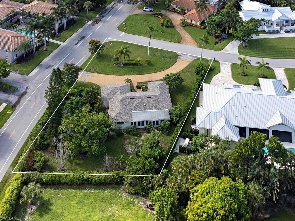 an aerial view of a house with a garden and lake view