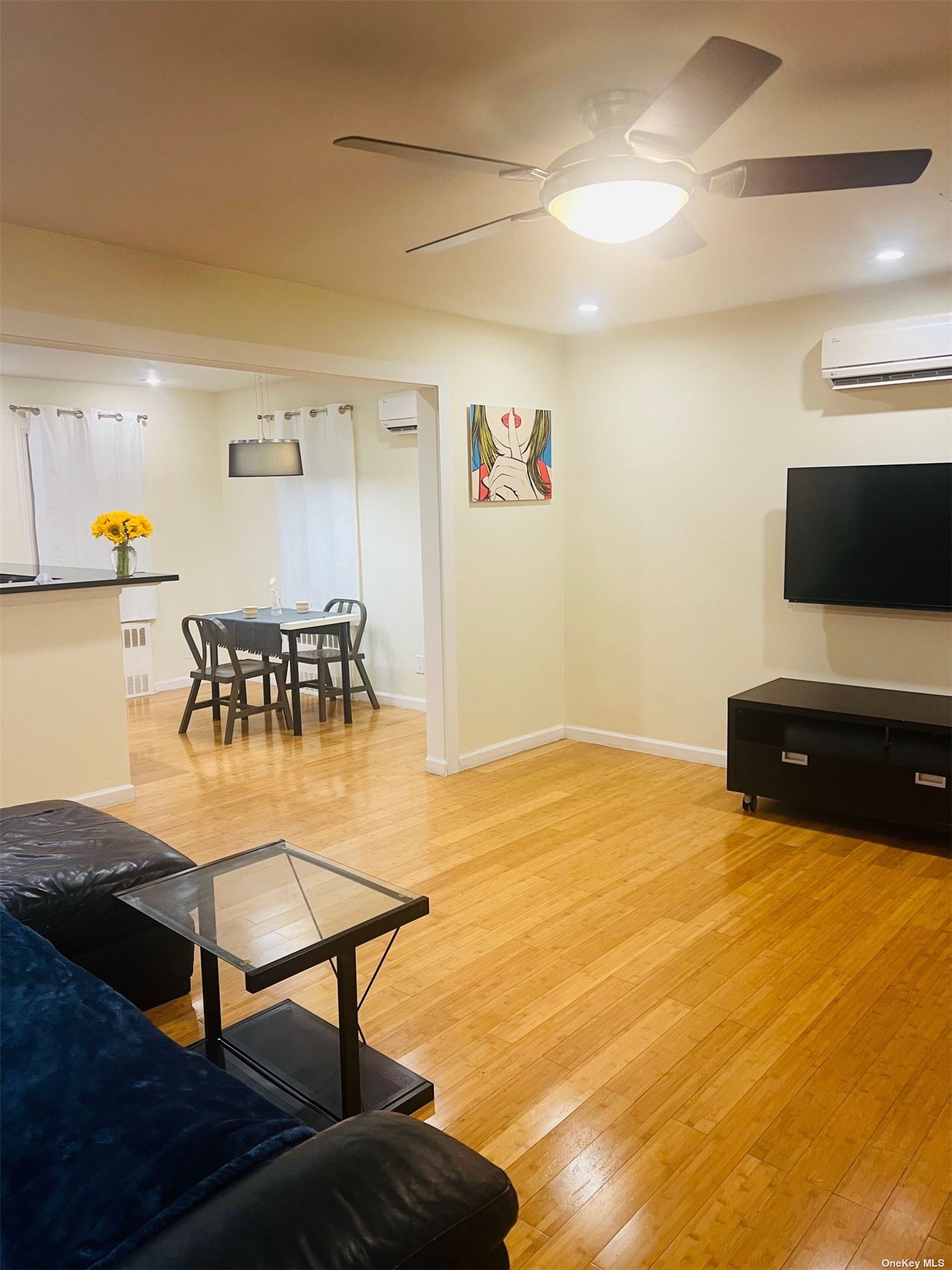 a living room with furniture and a flat screen tv