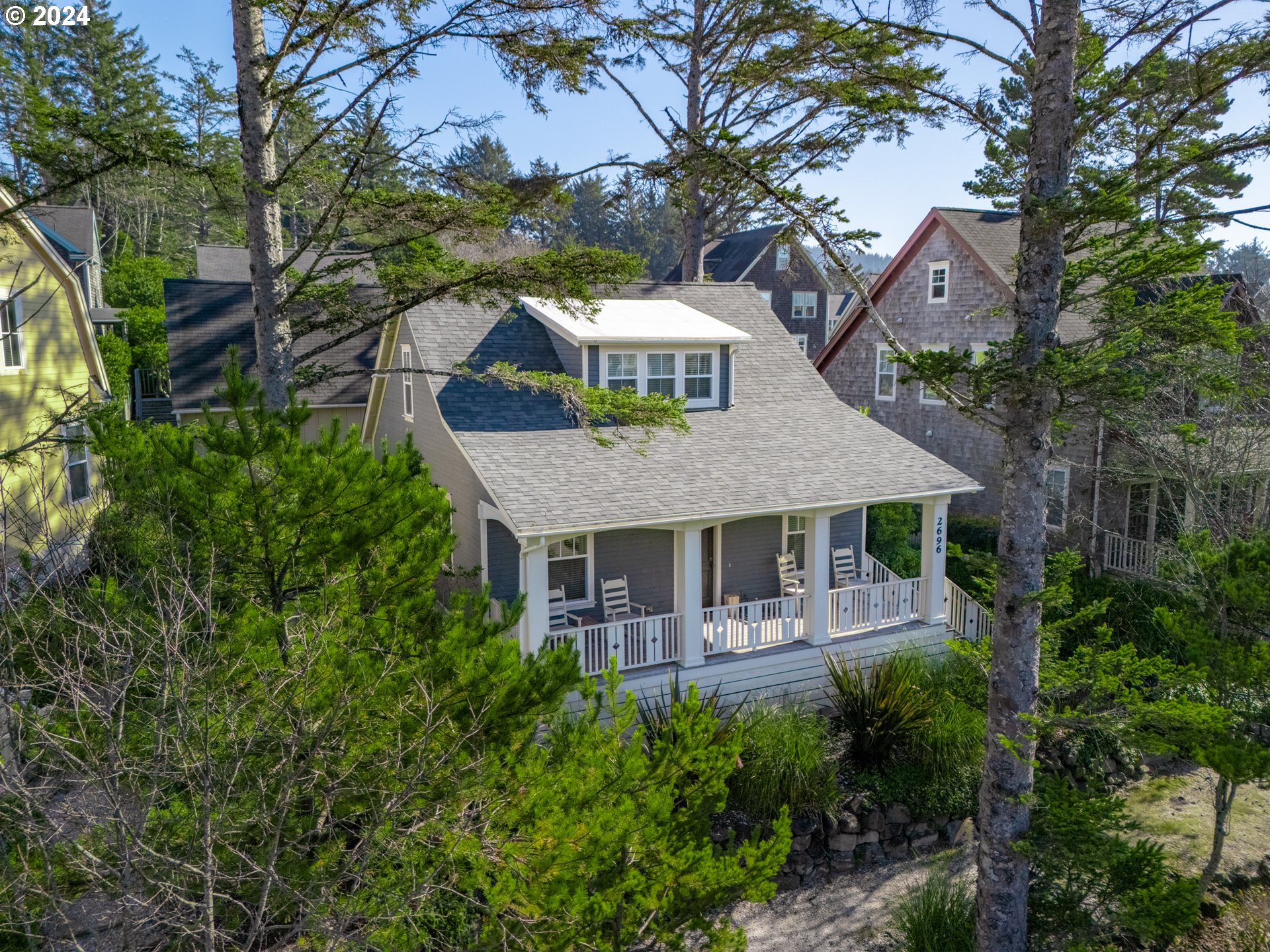 a aerial view of a house with swimming pool and porch with furniture