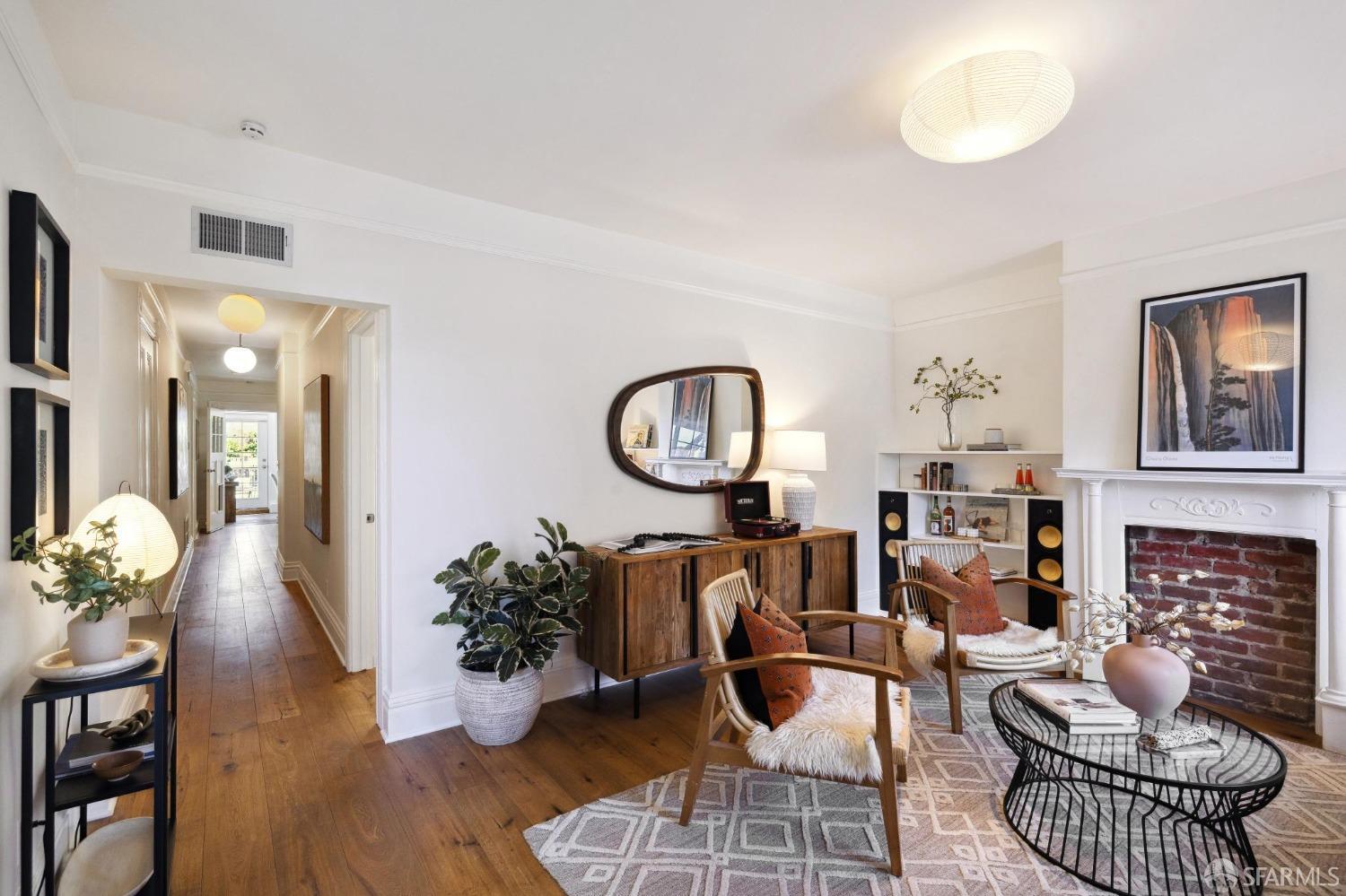 a living room with furniture a rug and a fireplace