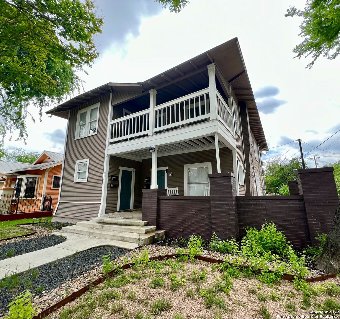 a front view of a house with garden