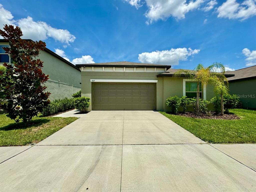 a front view of a house with a yard and garage