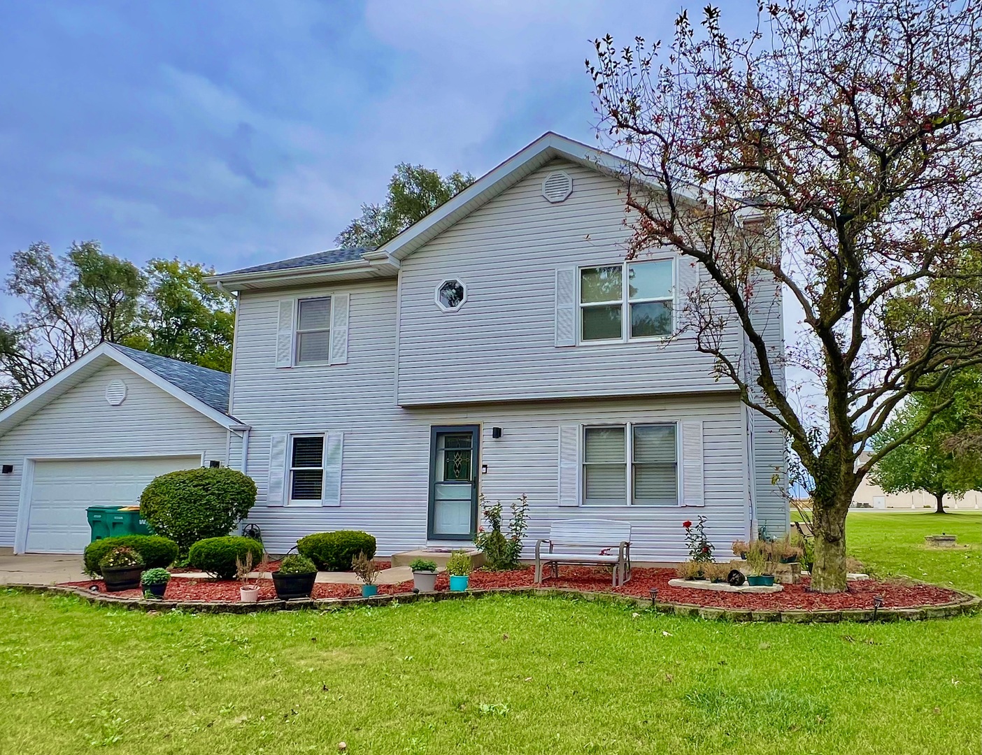 a front view of house with yard and green space