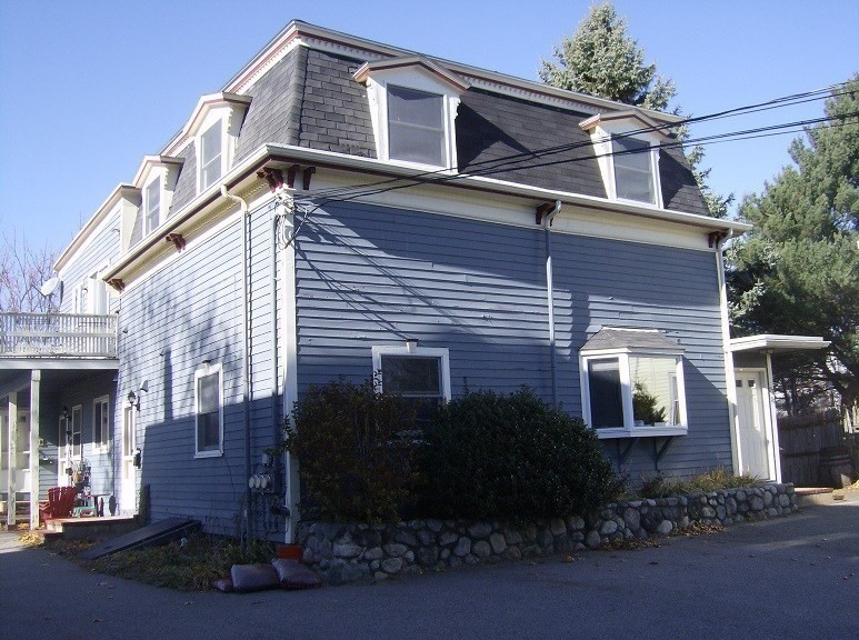 a view of a house with a yard and plants