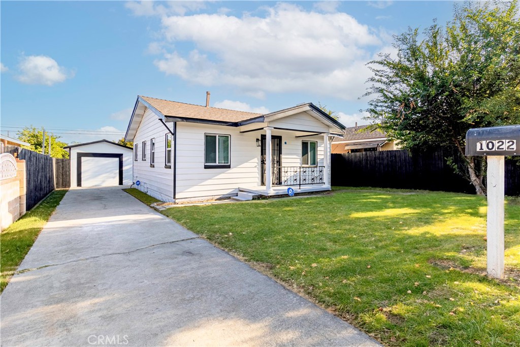 a front view of a house with yard and green space