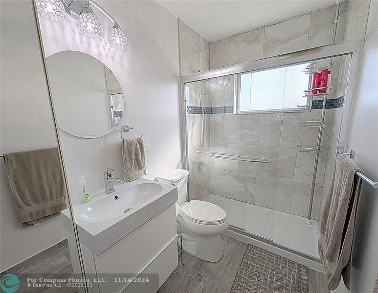 a bathroom with a sink toilet and shower