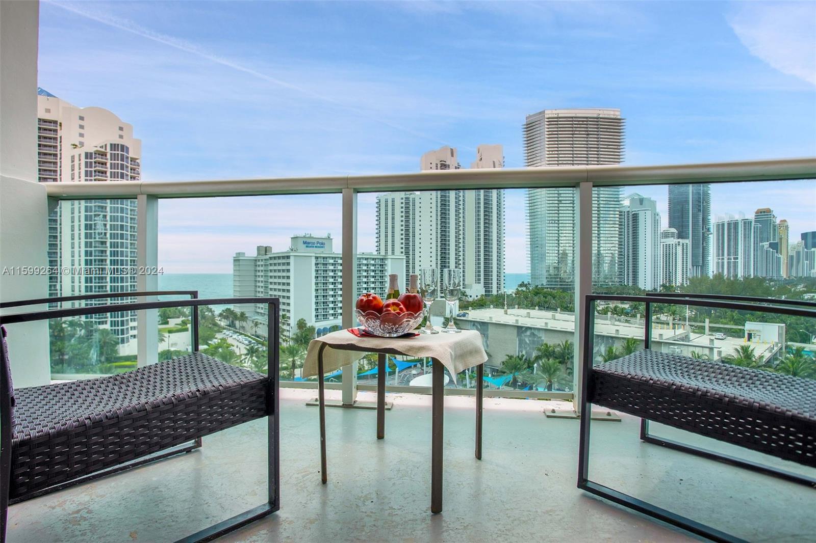 a balcony with table and chairs