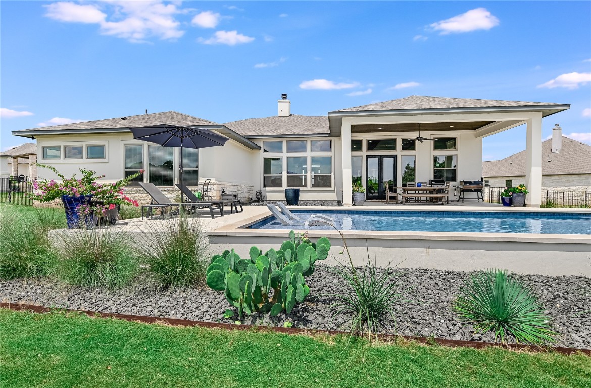 a front view of a house with a garden and patio