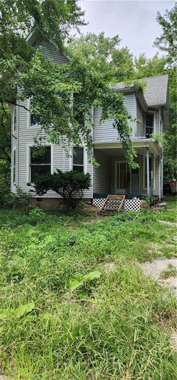 a view of a house with backyard garden and sitting area